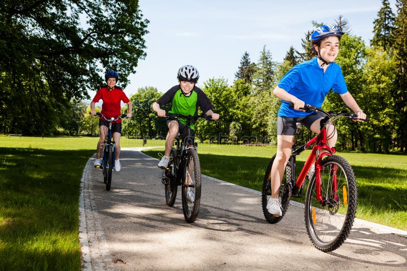 Mother and kids biking in park. Mother and kids biking in park