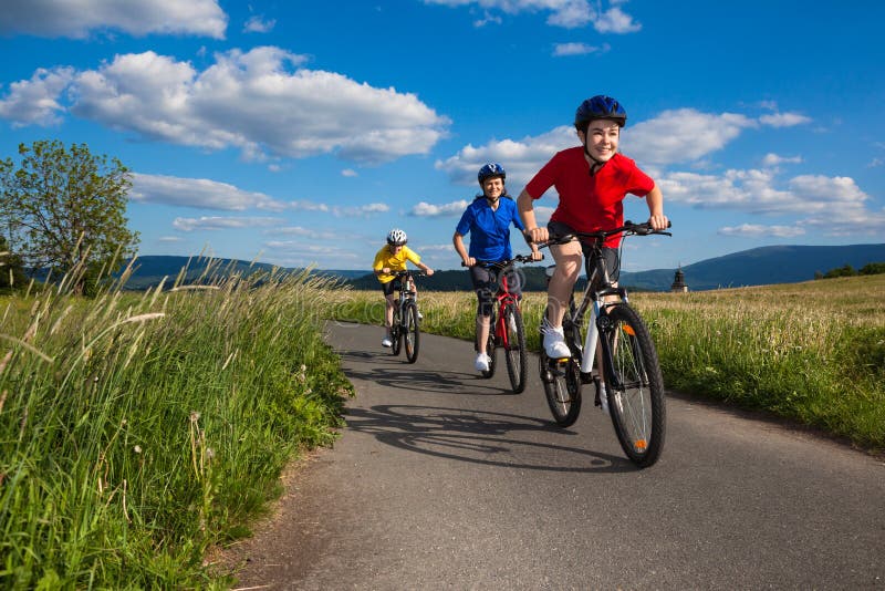 Active people - mother and kids biking. Active people - mother and kids biking