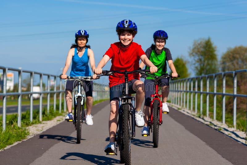 Active people - mother and kids biking. Active people - mother and kids biking