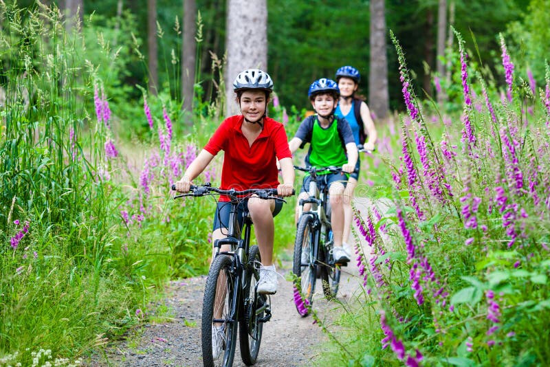 Mother and kids biking in forest. Mother and kids biking in forest