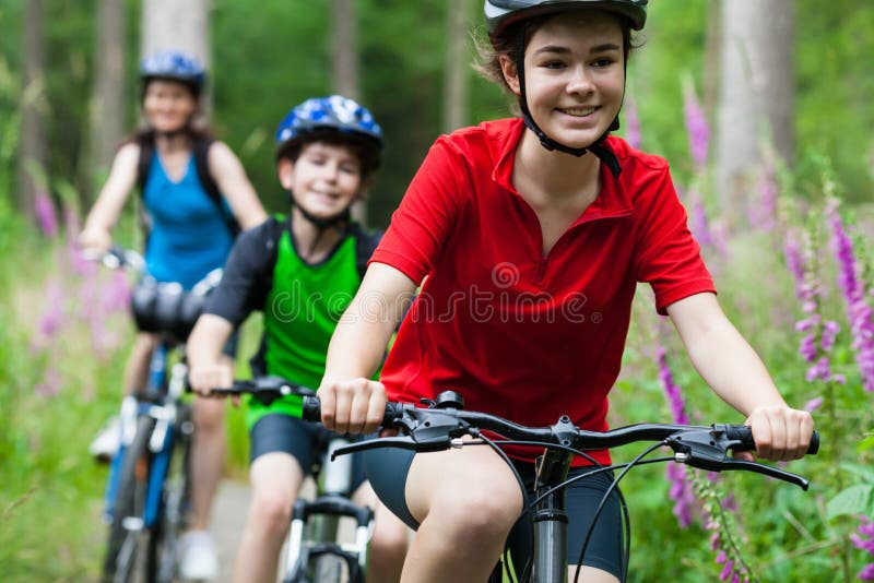Mother and kids biking in forest. Mother and kids biking in forest