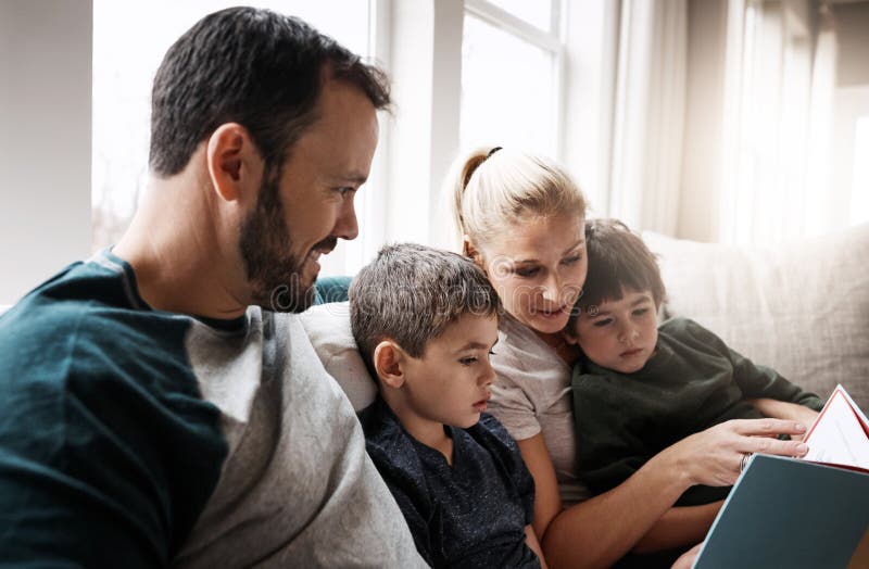 Family with book, reading with parents and children, happiness at home, story time and learning. Love, relationship and royalty free stock photography
