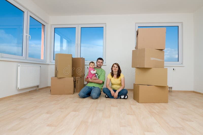 Family with boxes in new home