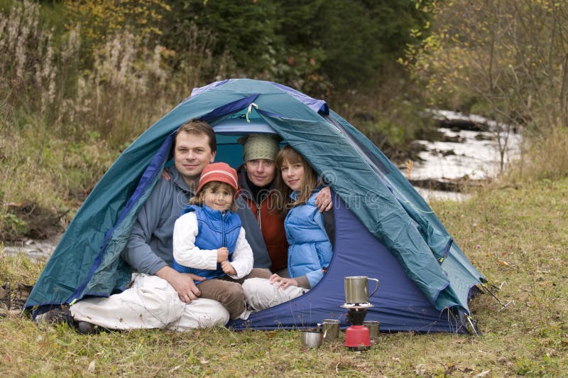 Asian Family on a Camping Trip Relax Outside Their Tent Stock Photo