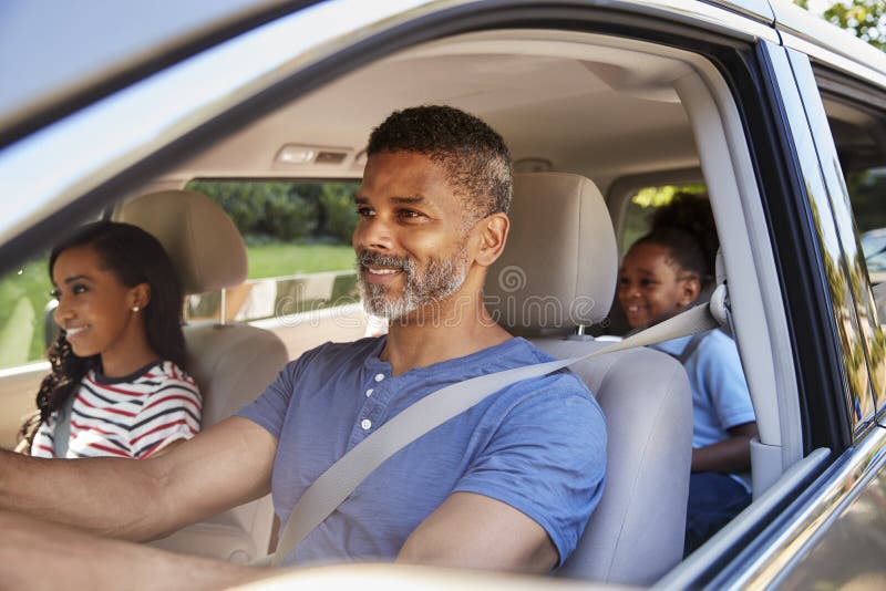 Family In Car Going On Road Trip