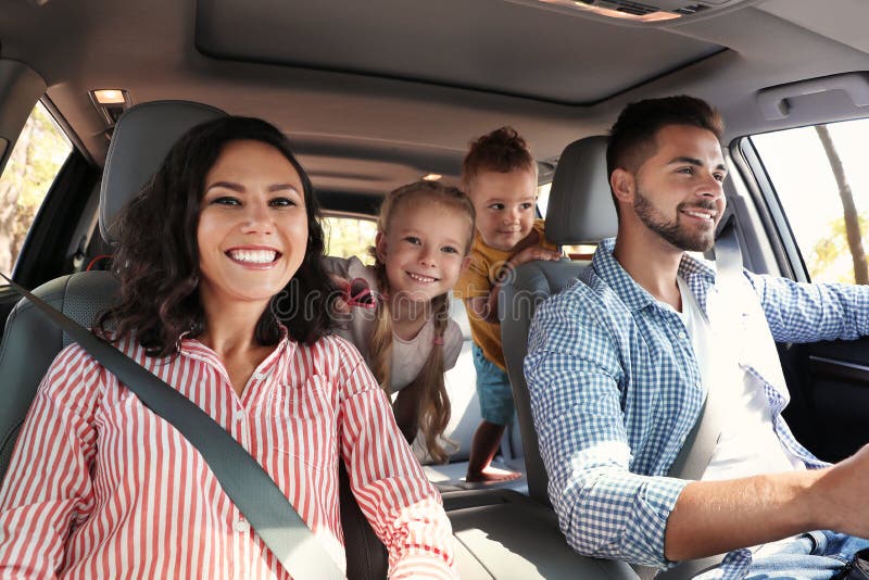 Happy family in car on road trip