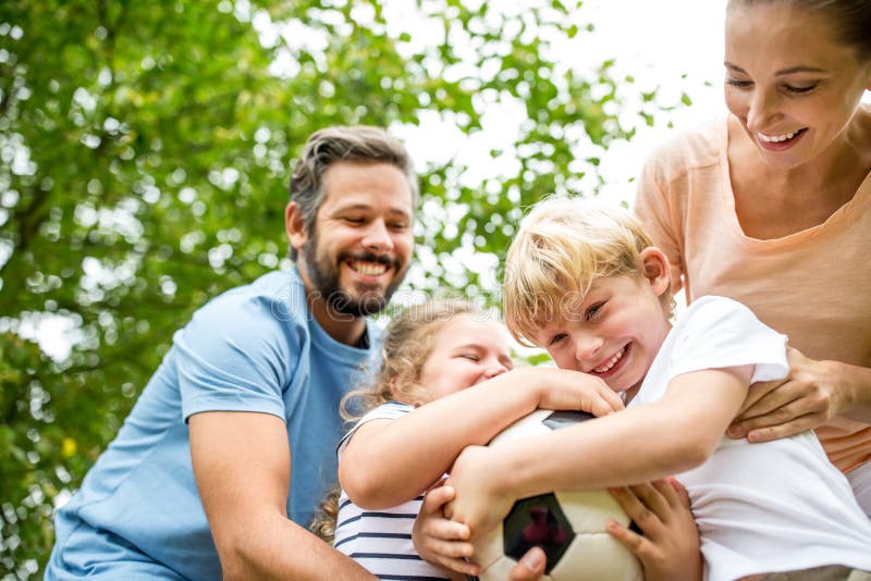 Family and children argue about football in the garden