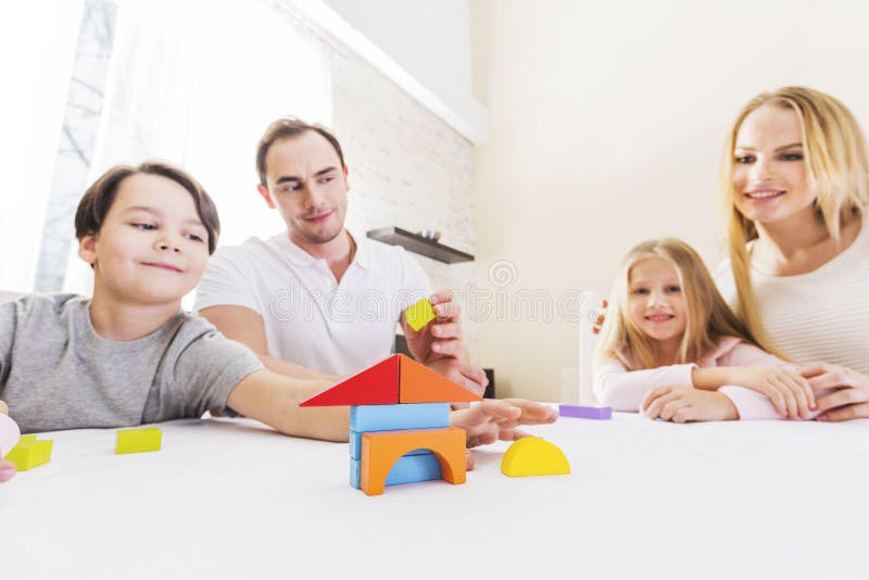 Family with children constructing house stock photo Family with children constructing house stock photo