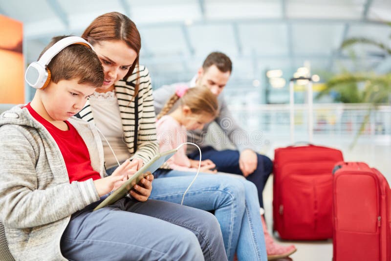 Family with children is waiting for the flight on vacation