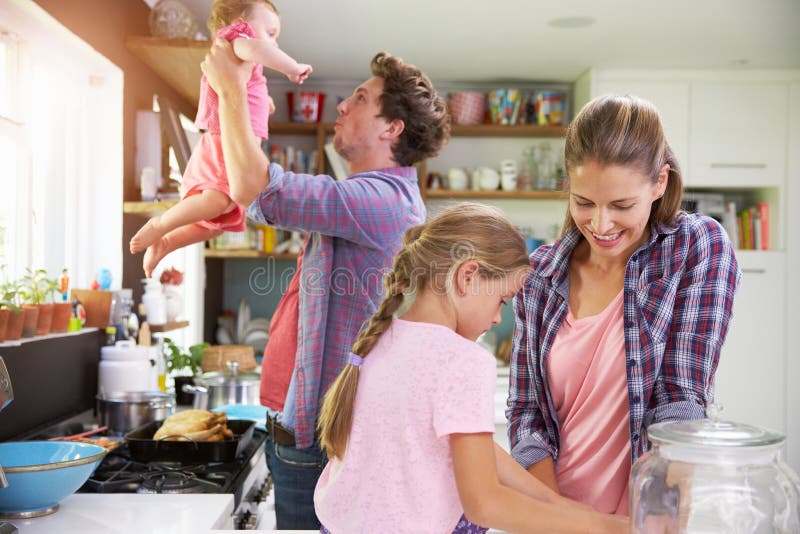 Family Cooking Meal In Kitchen Together stock image Family Cooking Meal In Kitchen Together stock image