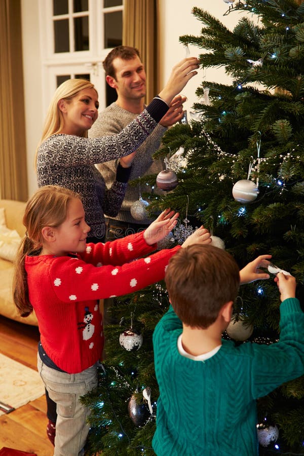 Family Unwrapping Gifts by Christmas Tree Stock Image - Image of ...
