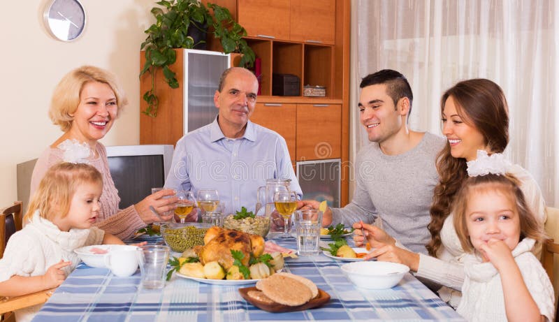 Family at the dining table stock image. Image of female - 68191697