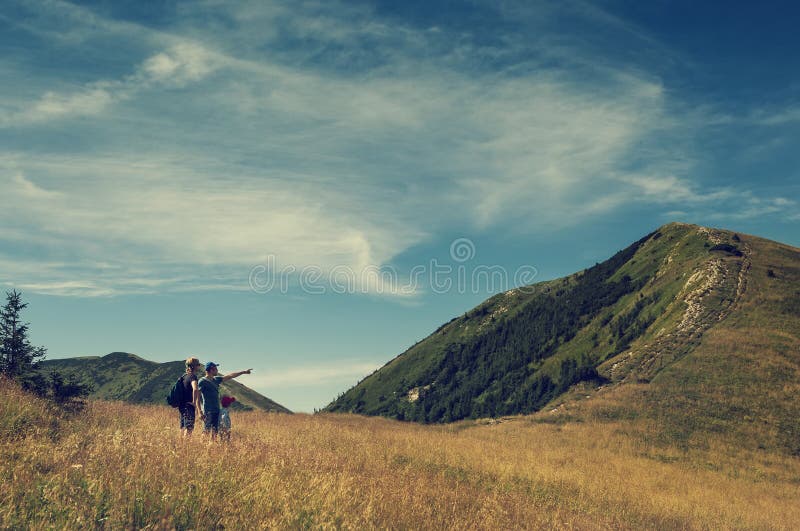 Family discuss about itinerary on the top of mountain hil