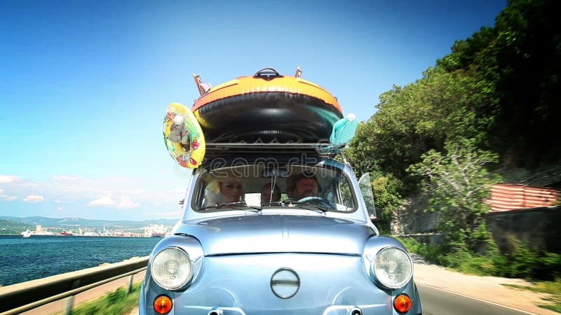 Family driving in small car across beautiful landscape