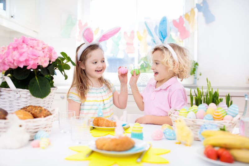 Easter egg hunt. Kids with bunny ears and basket.