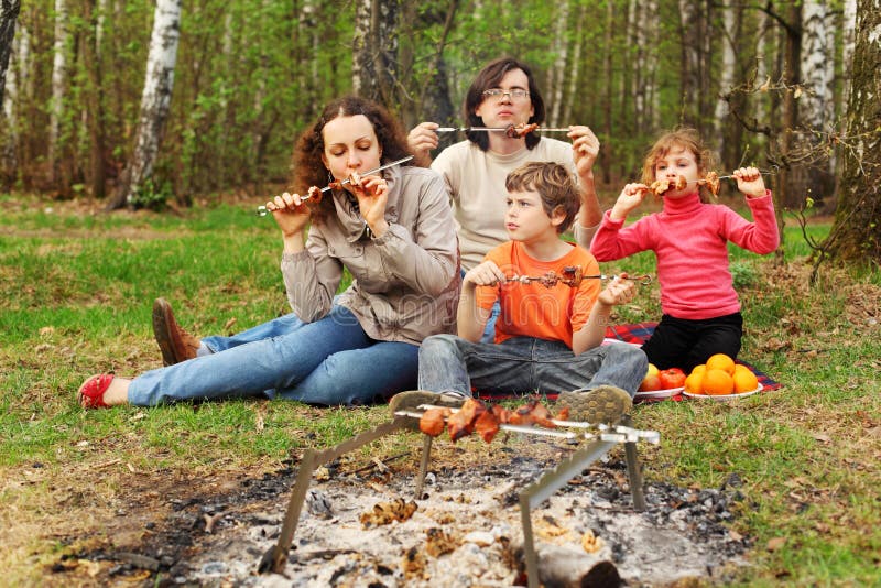 Family eat grilled shish kebab outdoor stock image Family eat grilled shish kebab outdoor stock image