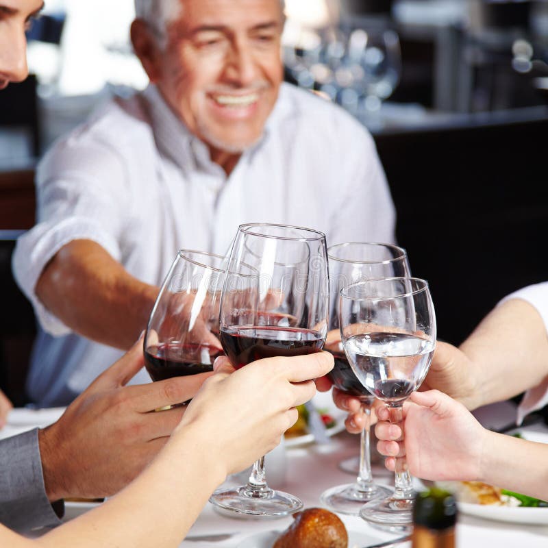 Family eating and drinking together stock photo