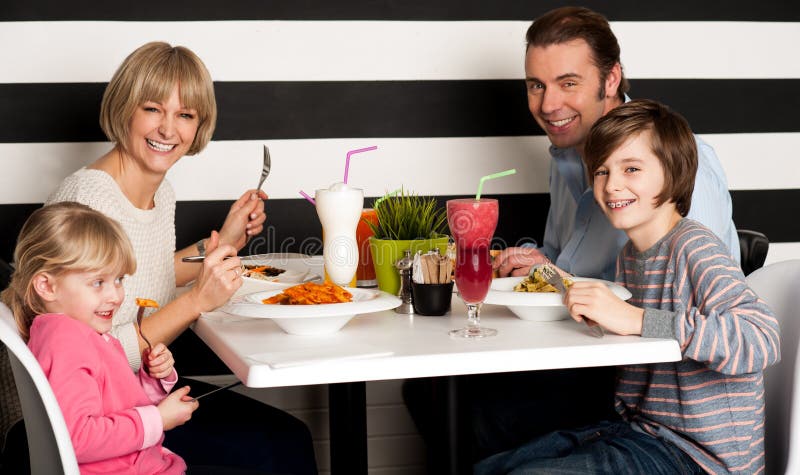Family Eating Lunch Together In Restaurant Stock Photo - Image of