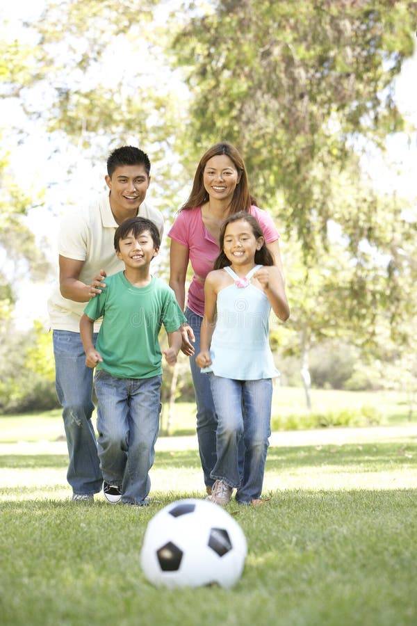 Asian Family Enjoying Day In Park