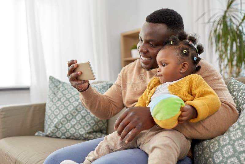 Happy father with baby taking selfie at home stock photo Happy father with baby taking selfie at home stock photo