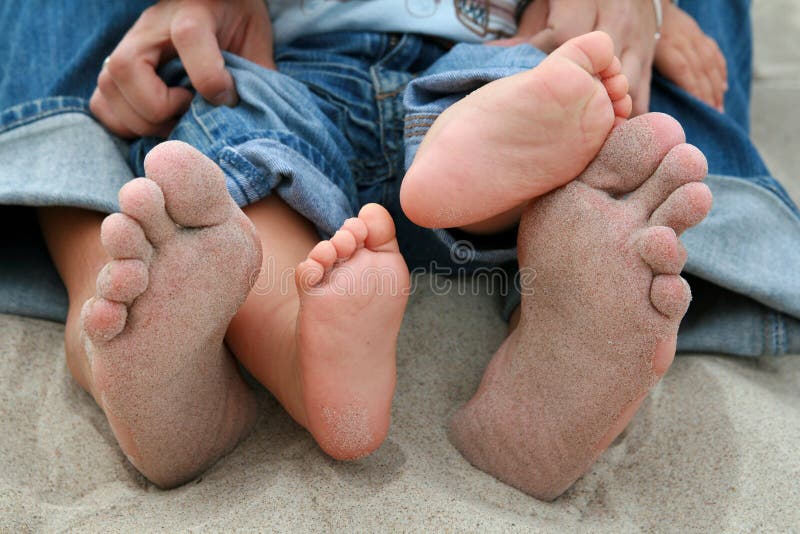 Family feet on sand