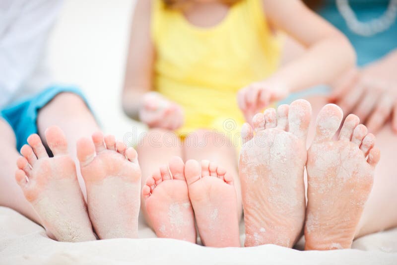 Family feet on sand royalty free stock photography