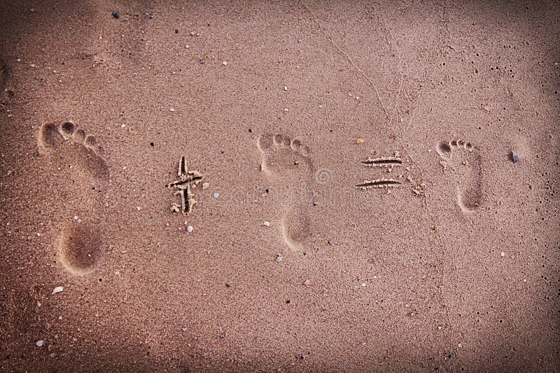 Family footprints in the sand on the seashore
