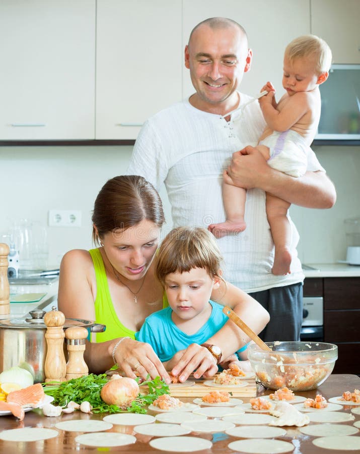 Family of Four with a Beautiful Kitchen Prepares Food Stock Image