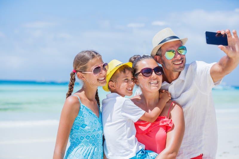 Family of four having fun at the beach