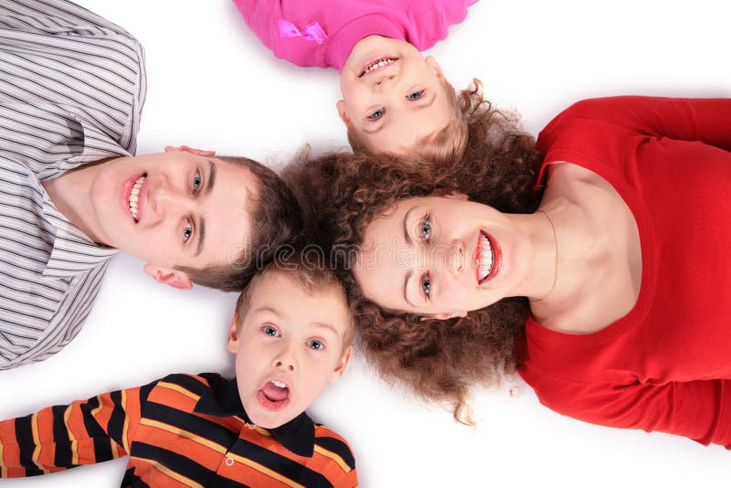 Family of four lying on floor