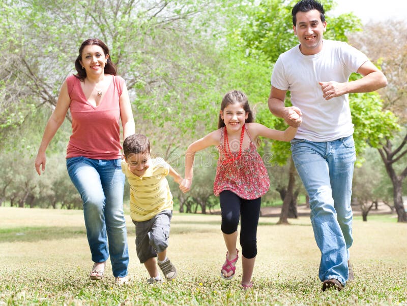 Family of four in the park stock image. Image of cheerful - 14312313