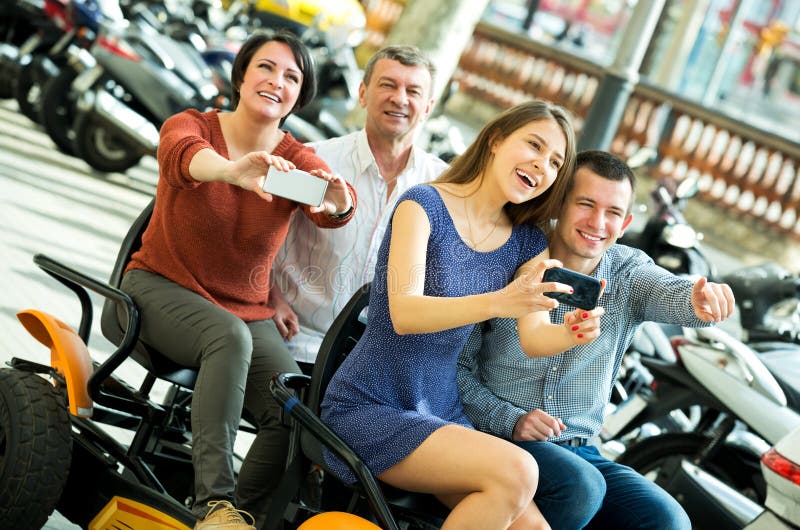 Family of four sitting in grand tour electric stock photo Family of four sitting in grand tour electric stock photo