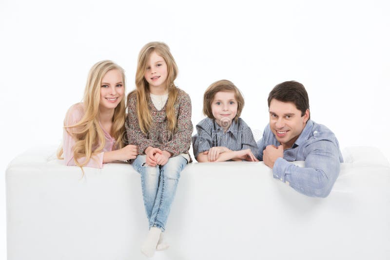 Family of four on a sofa at home royalty free stock image Family of four on a sofa at home royalty free stock image