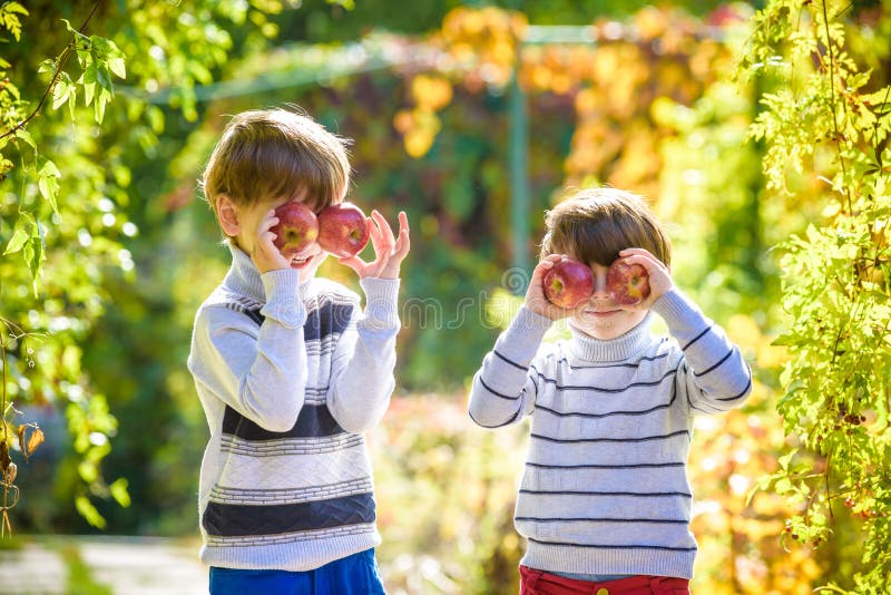 Family fun during harvest time on a farm. Kids playing in autumn stock image Family fun during harvest time on a farm. Kids playing in autumn stock image