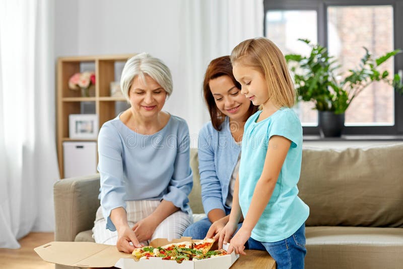 Mother, daughter and grandmother eating pizza