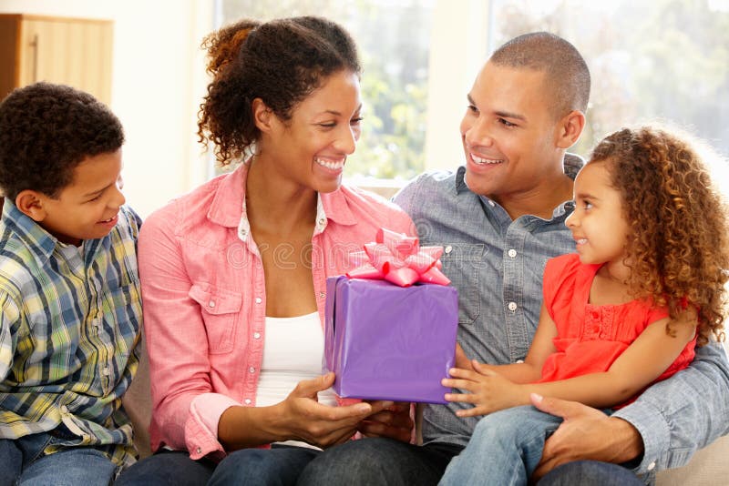 Family giving gift to mother royalty free stock photography Family giving gift to mother royalty free stock photography