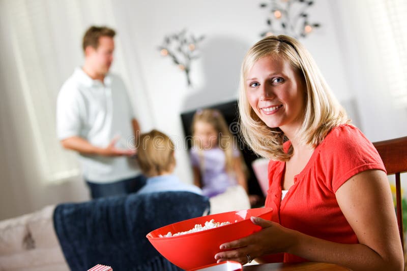 Family: Happy Woman Holds Big Bowl Of Popcorn Before Movie Night