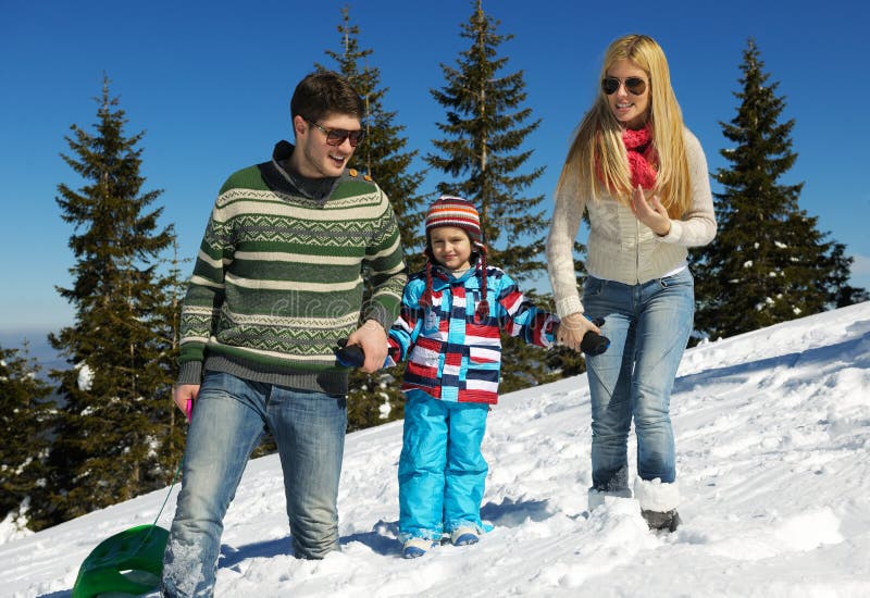 Winter season. Happy family having fun on fresh snow on vacation. Winter season. Happy family having fun on fresh snow on vacation.