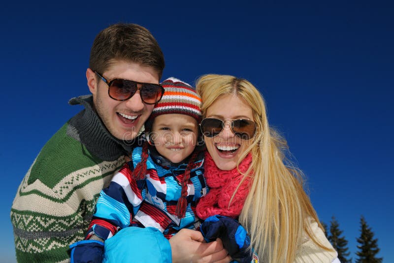 Winter season. Happy family having fun on fresh snow on vacation. Winter season. Happy family having fun on fresh snow on vacation.