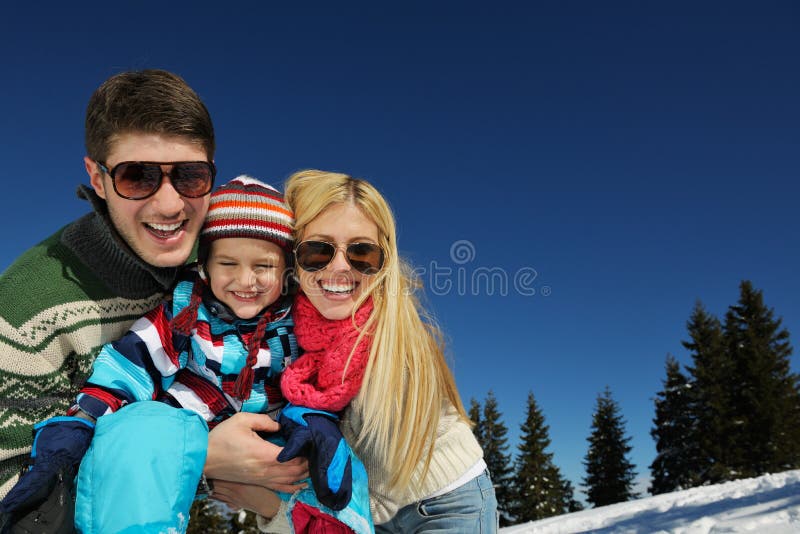 Winter season. Happy family having fun on fresh snow on vacation. Winter season. Happy family having fun on fresh snow on vacation.