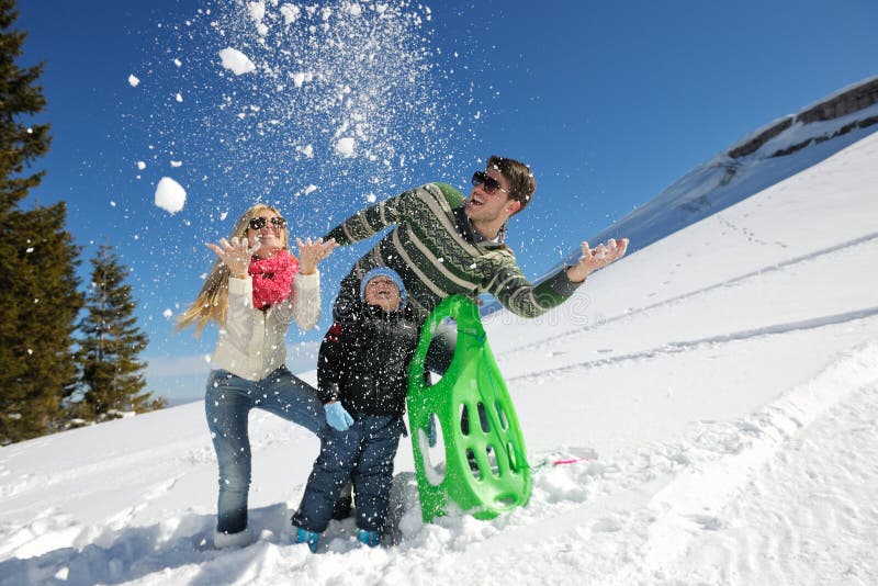 Winter season. Happy family having fun on fresh snow on vacation. Winter season. Happy family having fun on fresh snow on vacation.