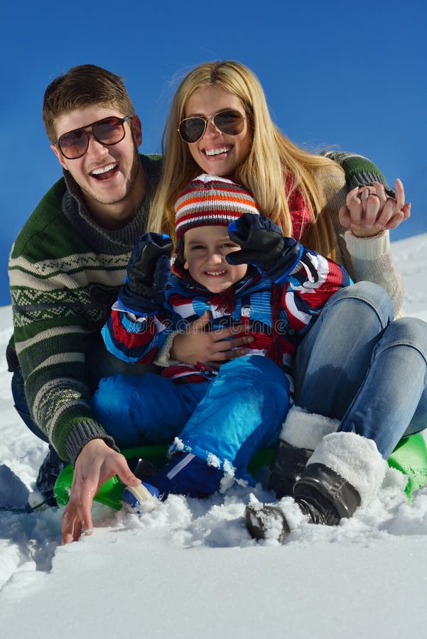 Winter season. Happy family having fun on fresh snow on vacation. Winter season. Happy family having fun on fresh snow on vacation.