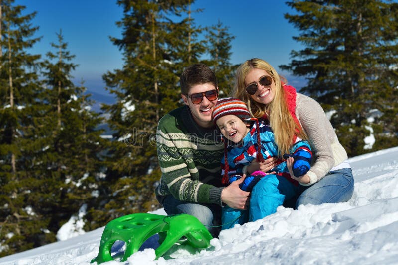 Winter season. Happy family having fun on fresh snow on vacation. Winter season. Happy family having fun on fresh snow on vacation.