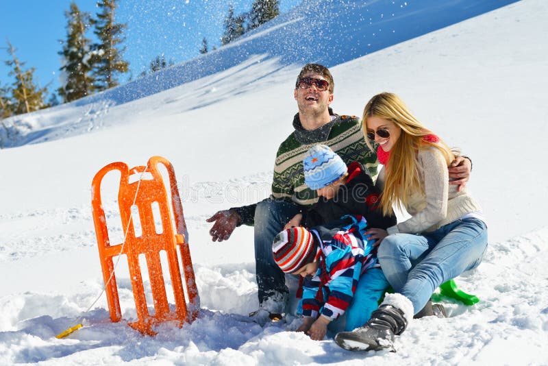 Winter season. Happy family having fun on fresh snow on vacation. Winter season. Happy family having fun on fresh snow on vacation.