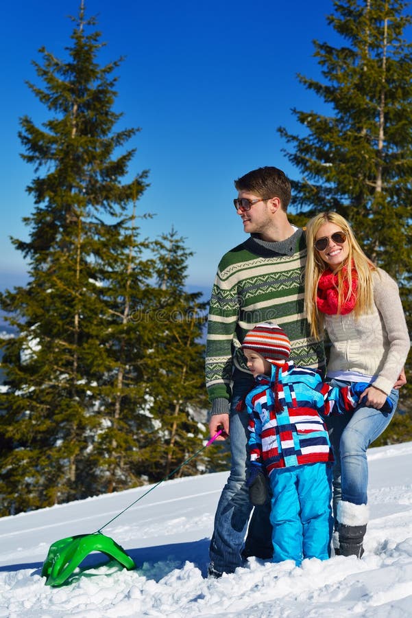 Winter season. Happy family having fun on fresh snow on vacation. Winter season. Happy family having fun on fresh snow on vacation.