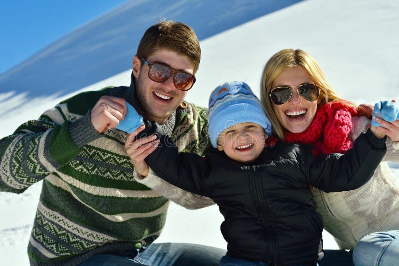 Winter season. Happy family having fun on fresh snow on vacation. Winter season. Happy family having fun on fresh snow on vacation.