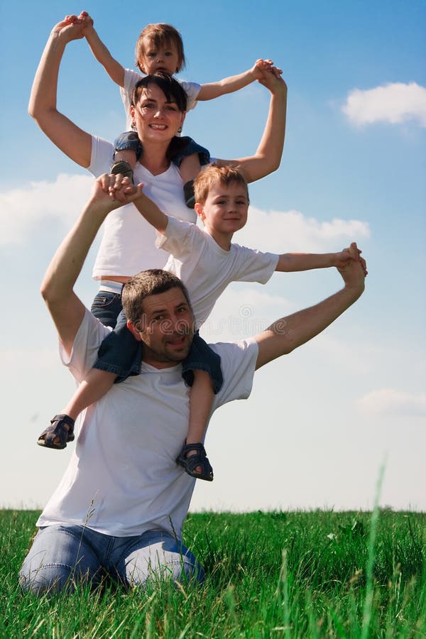 Eine glückliche Familie Spaß draußen in der grünen wiese.