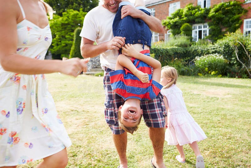 Family Having Fun Playing In Garden royalty free stock photos Family Having Fun Playing In Garden royalty free stock photos