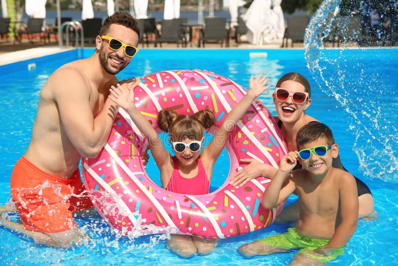 Family having fun in swimming pool