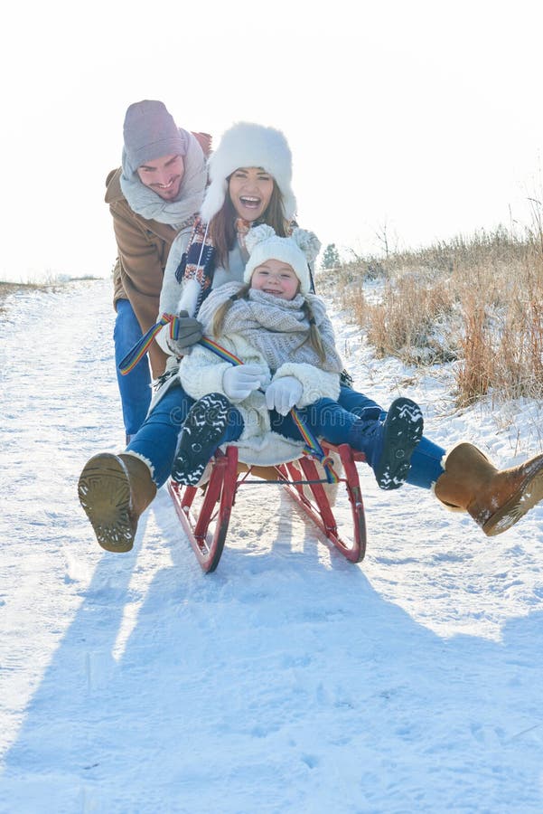 Family having fun with toboggan royalty free stock photo Family having fun with toboggan royalty free stock photo